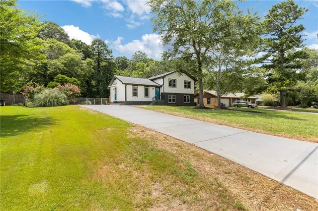 a view of a house with swimming pool and porch