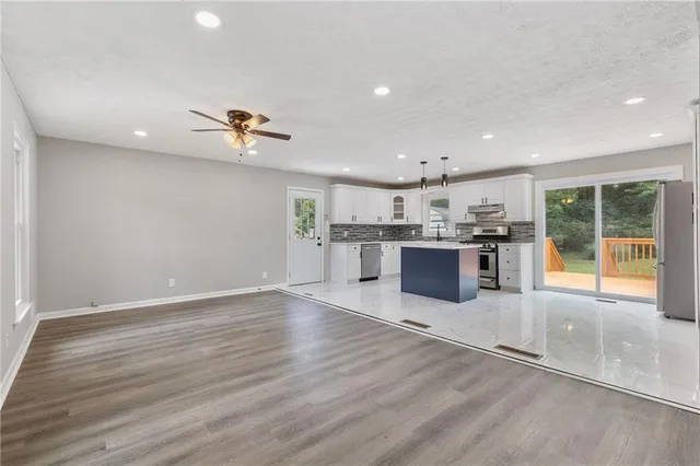 a kitchen with stainless steel appliances granite countertop a stove sink and cabinets