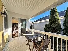 a view of a chairs and table in the balcony