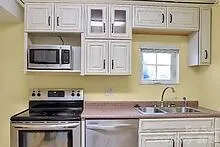 a kitchen with stainless steel appliances granite countertop a stove and a microwave