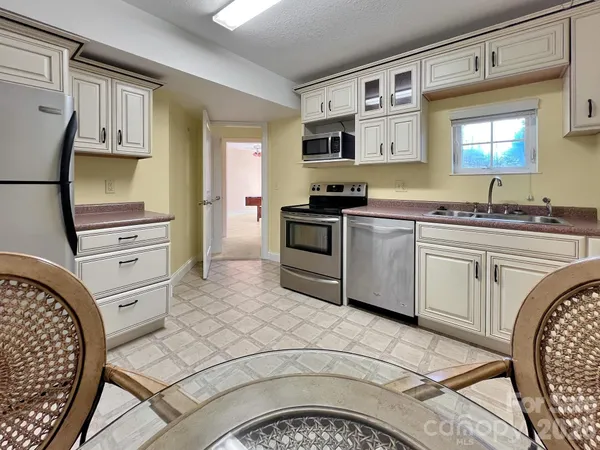 a kitchen with stainless steel appliances granite countertop a sink and cabinets
