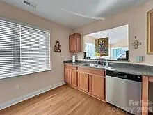 a kitchen with granite countertop a sink cabinets and window