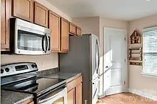 a kitchen with stainless steel appliances granite countertop a refrigerator and a sink