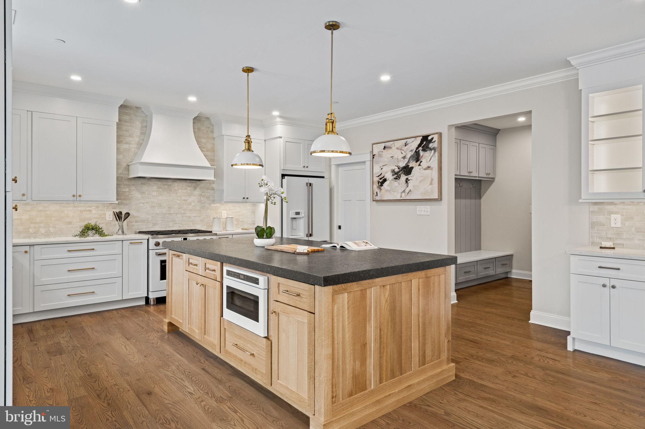 305 Glenway Road Glenside, PA 19038 - Photo 37 of 93 a kitchen with stainless steel appliances granite countertop a stove and white cabinets with wooden floor