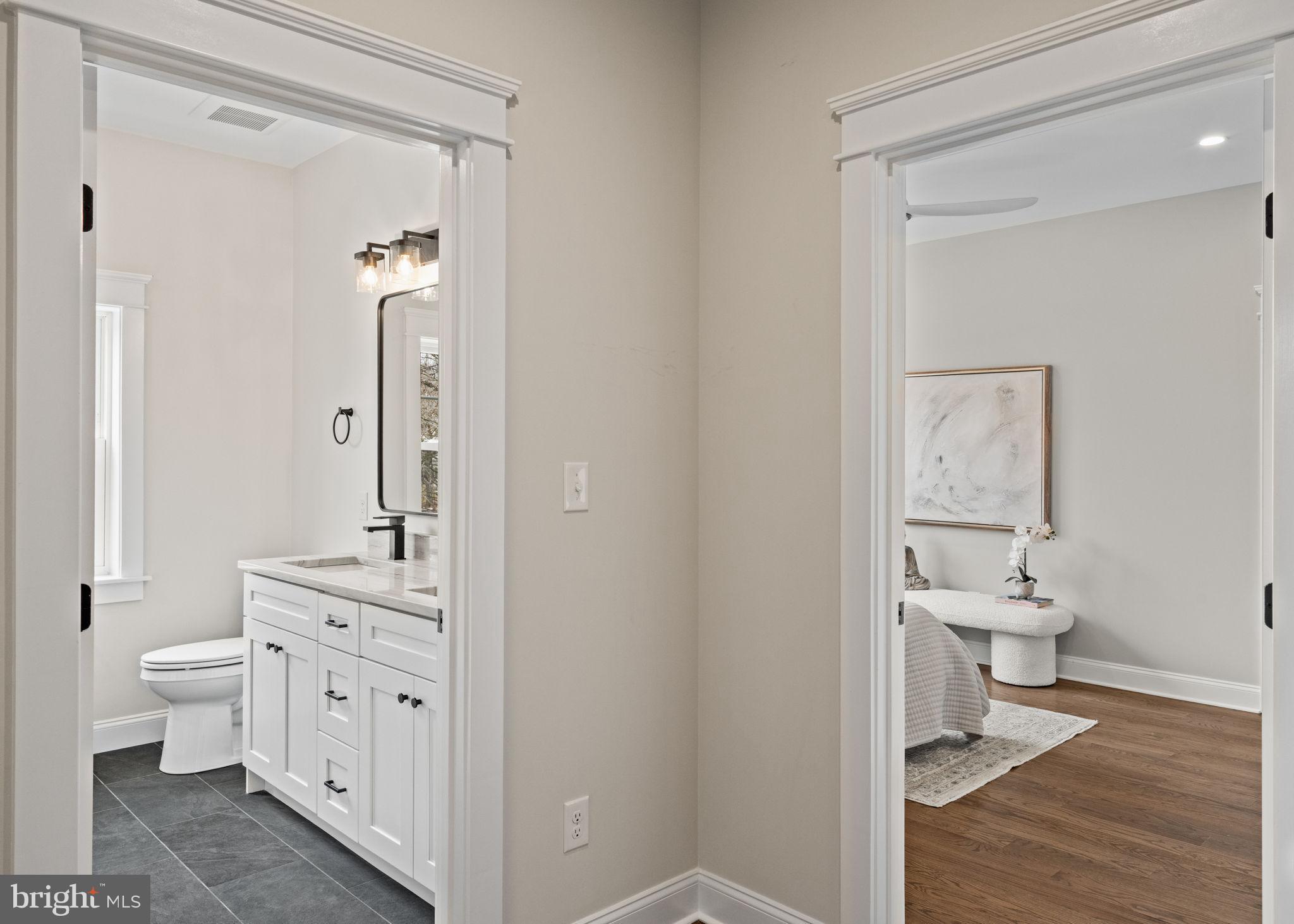 305 Glenway Road Glenside, PA 19038 - Photo 57 of 93 a bathroom with a granite countertop toilet a sink and a mirror