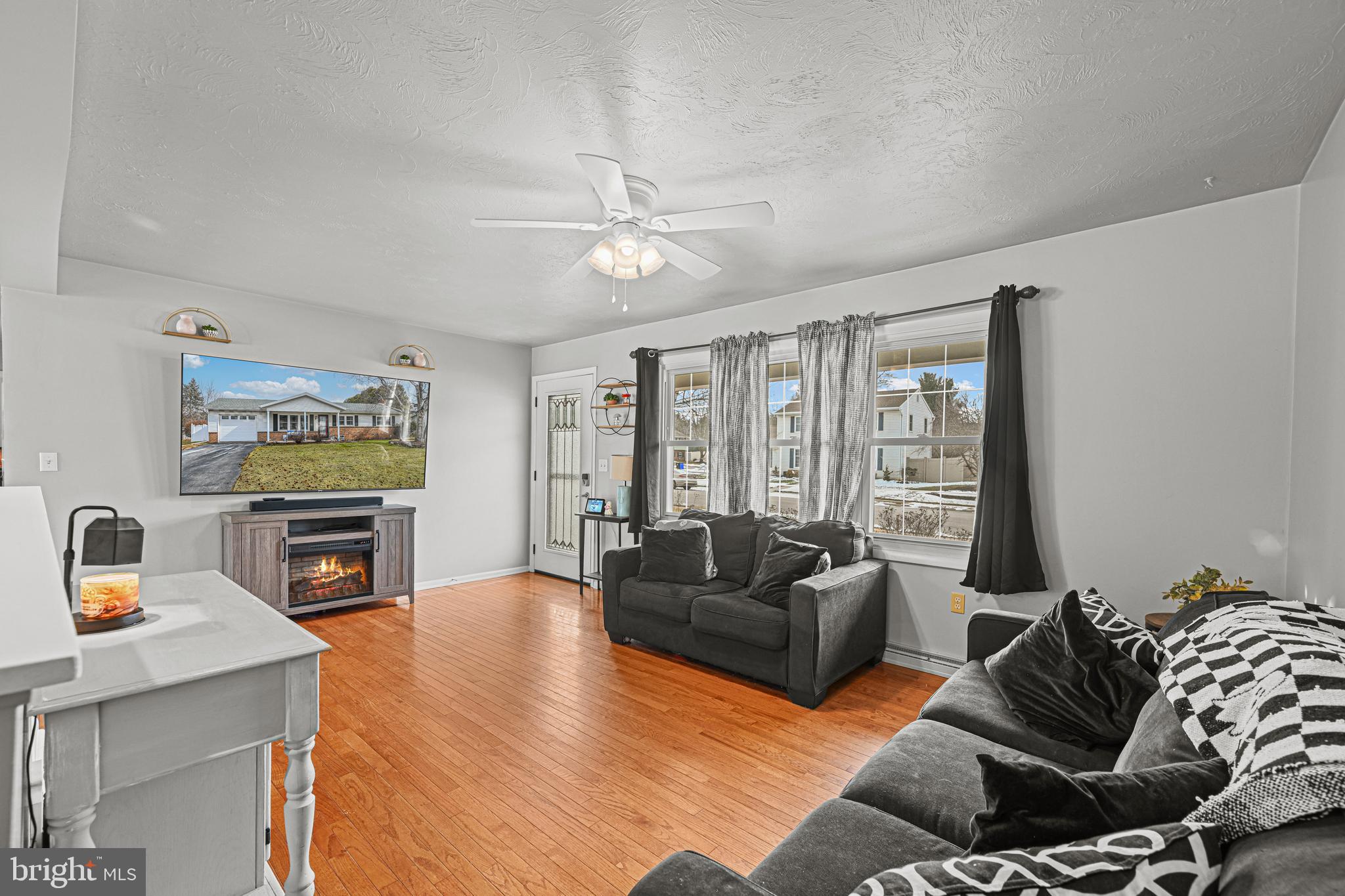 3541 Village Road Dover, PA 17315 - Photo 4 of 36 a living room with fireplace furniture and a flat screen tv