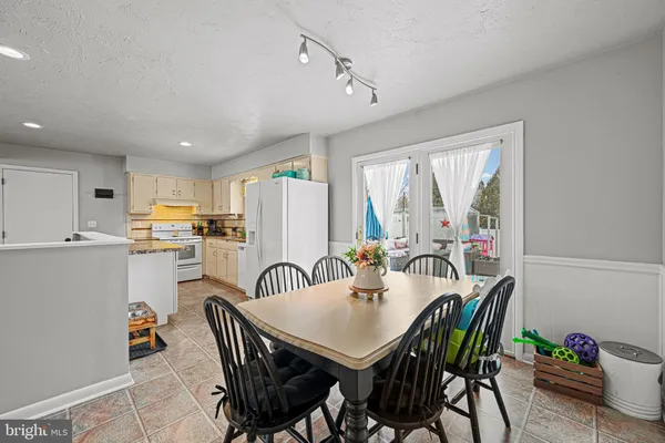 a view of a dining room with furniture window and outside view