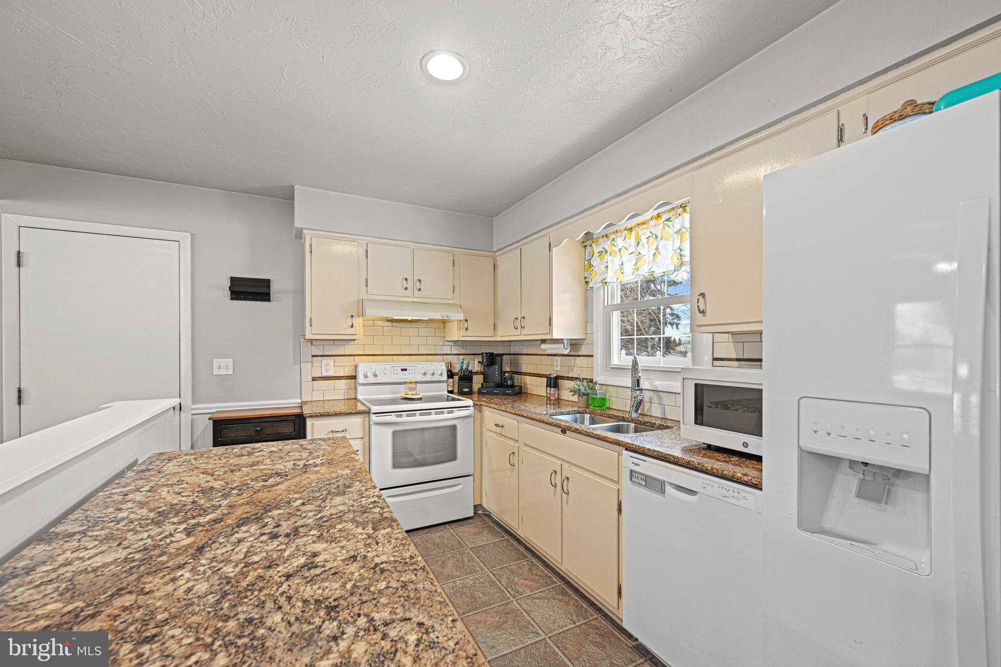 3541 Village Road Dover, PA 17315 - Photo 8 of 36 a kitchen with stainless steel appliances granite countertop a stove a sink and a refrigerator