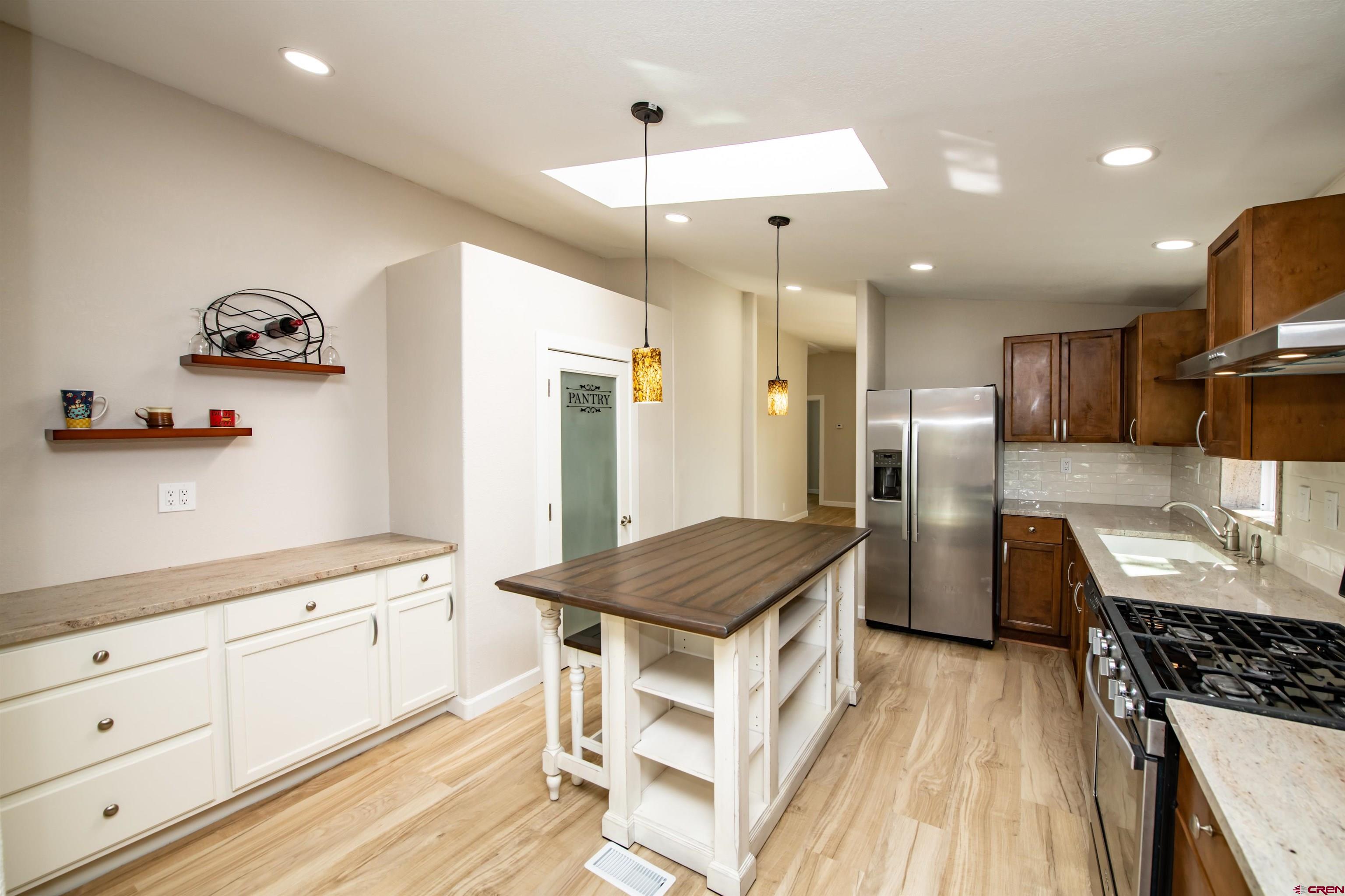 475 Run Around Road Arboles, CO 81121 - Photo 12 of 40 a kitchen with a sink stove and refrigerator