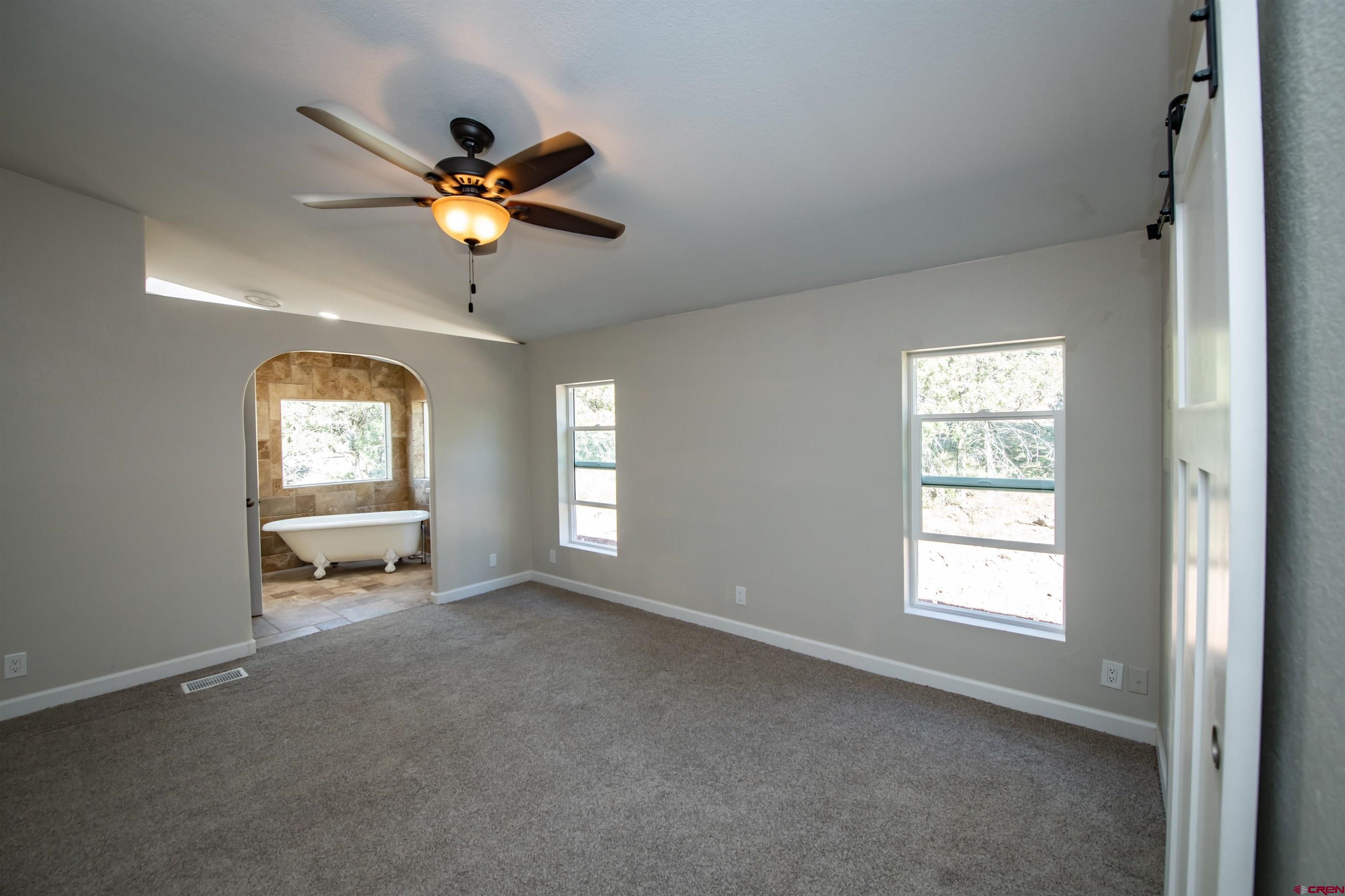 475 Run Around Road Arboles, CO 81121 - Photo 18 of 40 a view of a livingroom with a window and a ceiling fan