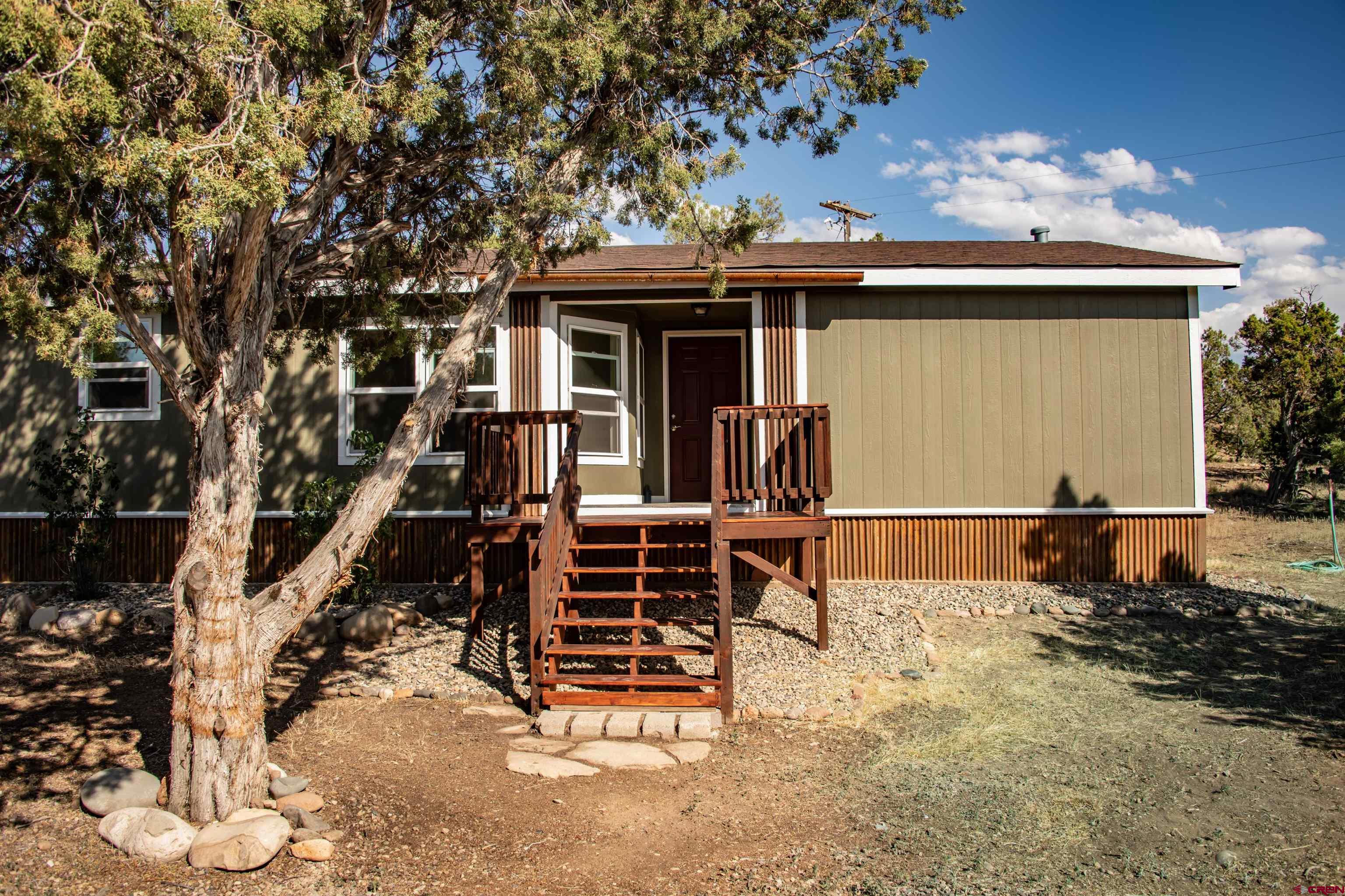 475 Run Around Road Arboles, CO 81121 - Photo 2 of 40 front view of a house with a porch