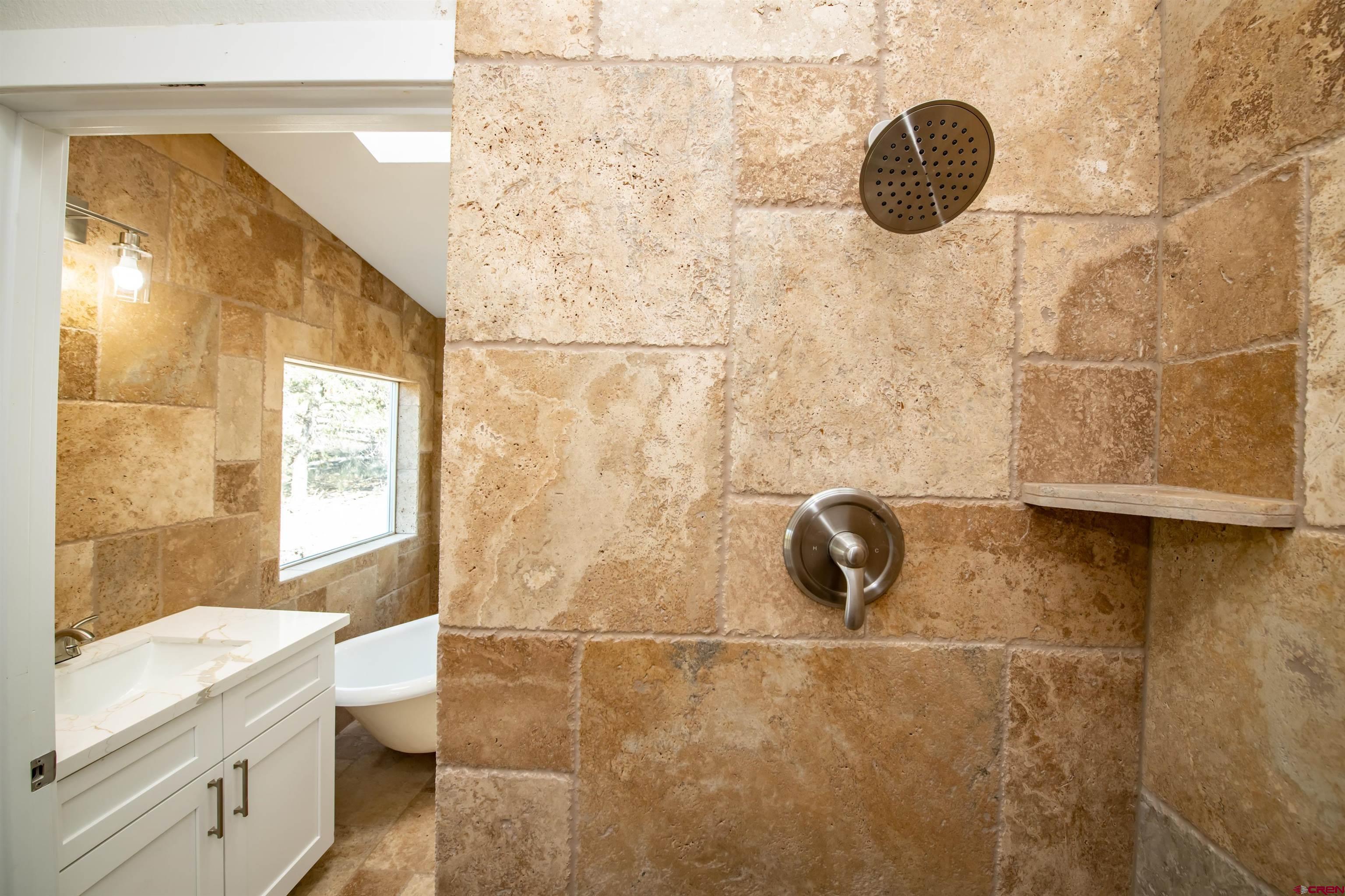 475 Run Around Road Arboles, CO 81121 - Photo 22 of 40 a bathroom with a granite countertop sink a toilet and shower