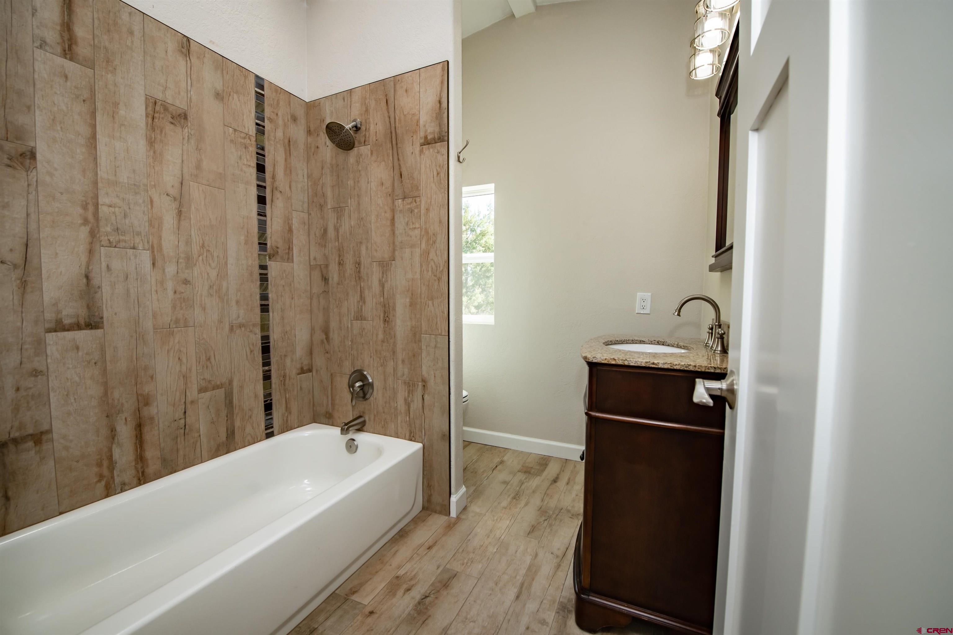 475 Run Around Road Arboles, CO 81121 - Photo 27 of 40 a bathroom with a tub a sink and a shower