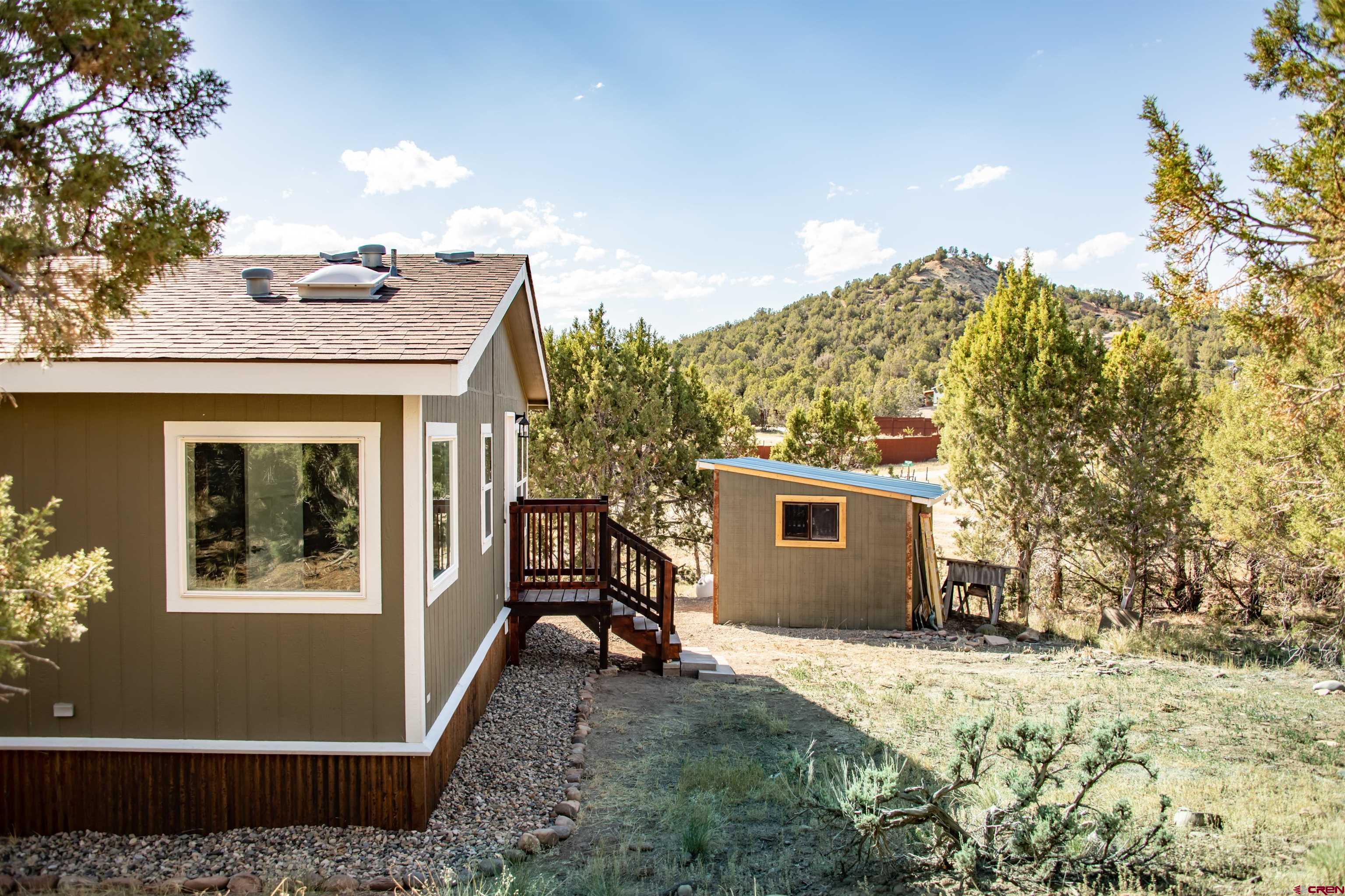 475 Run Around Road Arboles, CO 81121 - Photo 30 of 40 a view of a house with a yard