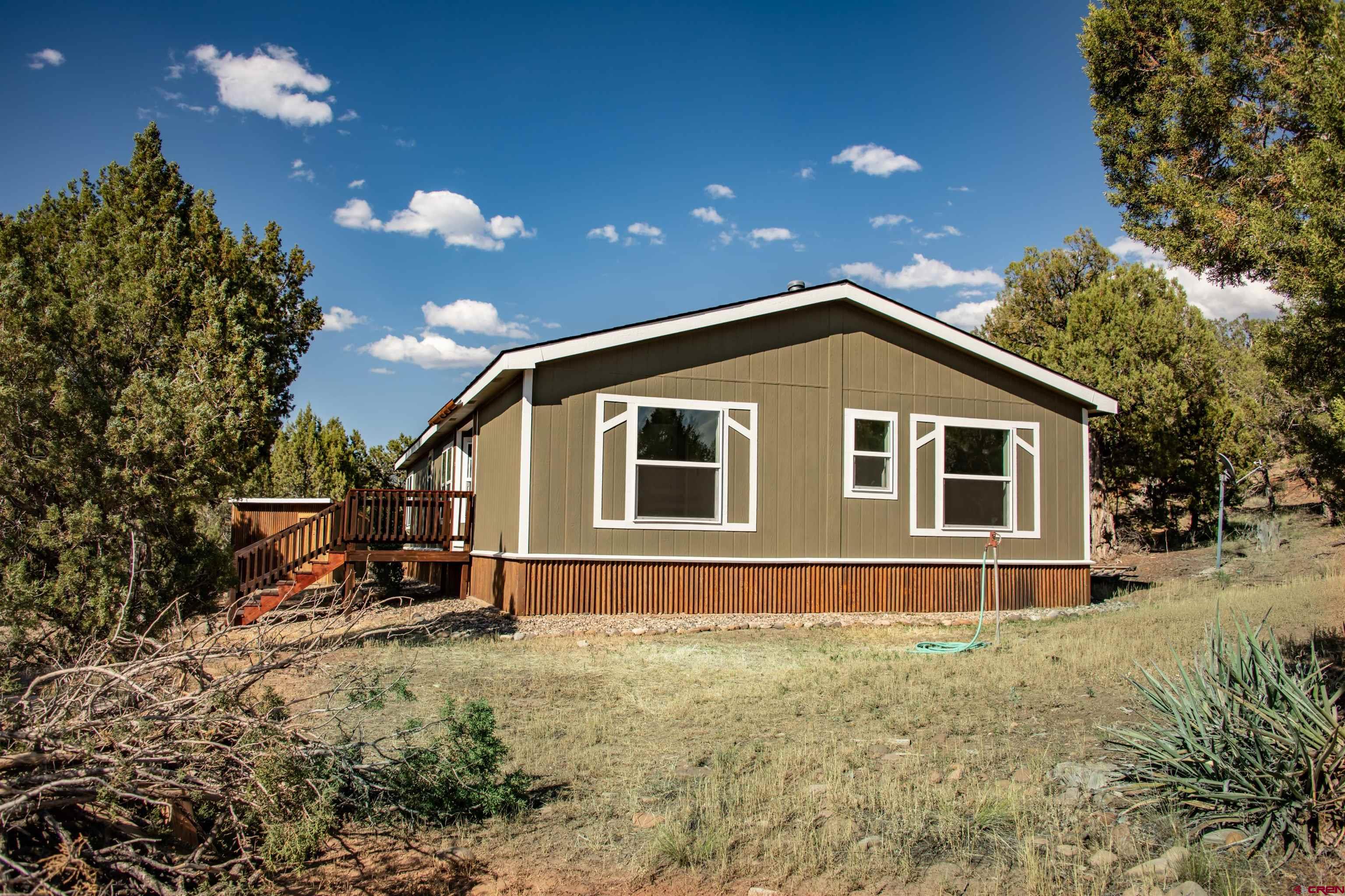 475 Run Around Road Arboles, CO 81121 - Photo 35 of 40 a front view of a house with a yard