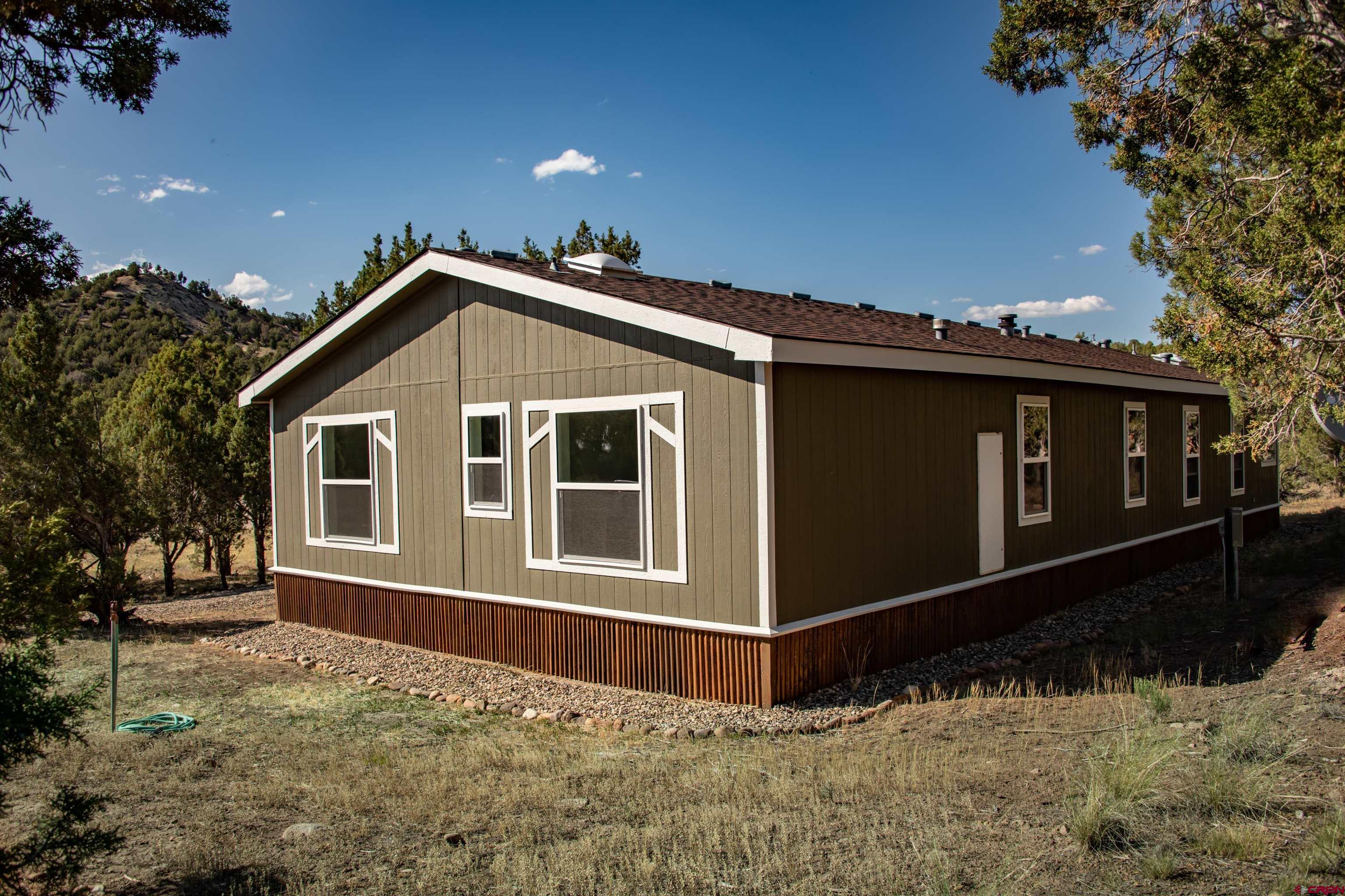 475 Run Around Road Arboles, CO 81121 - Photo 36 of 40 a front view of a house with a yard