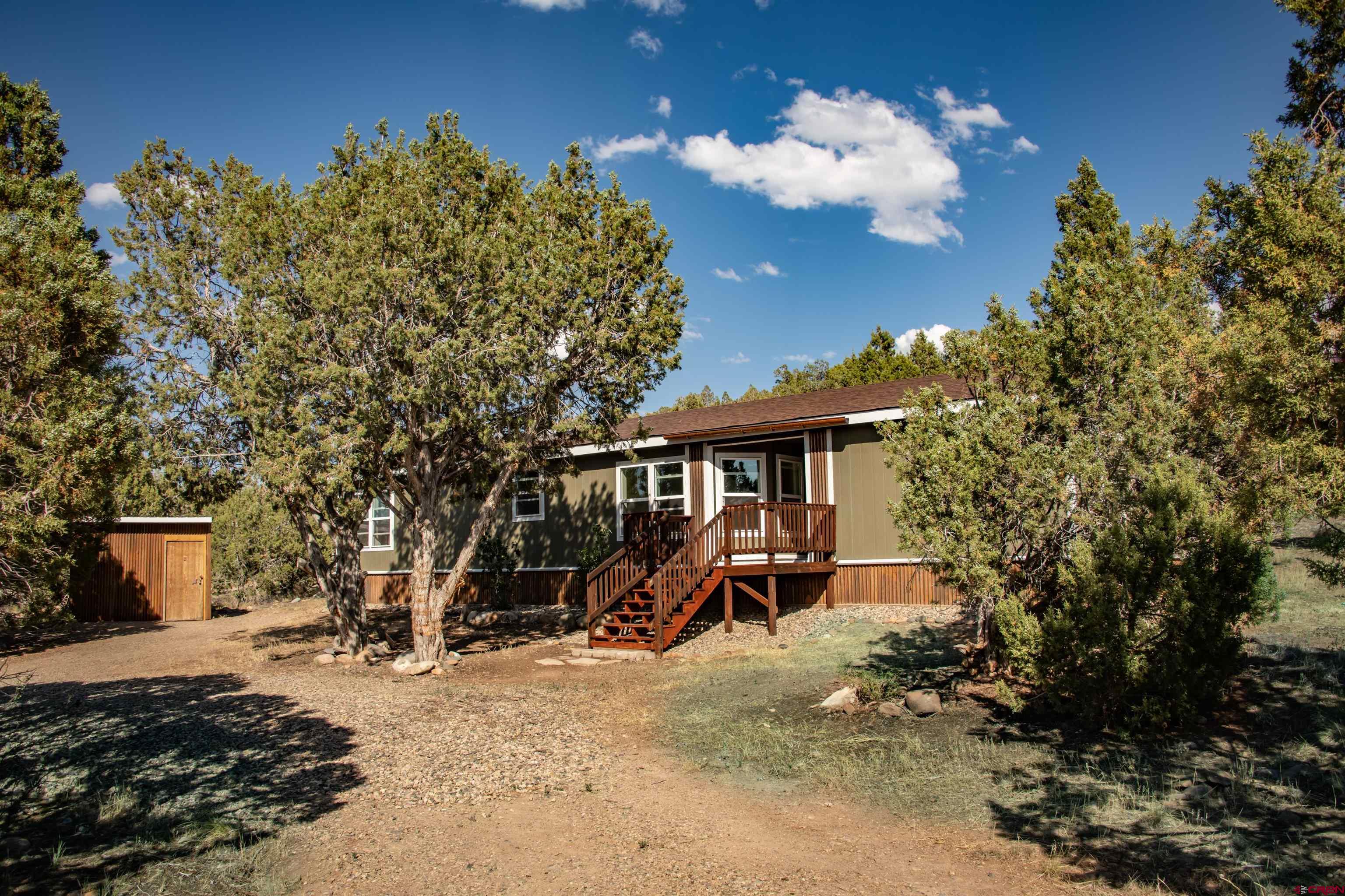 475 Run Around Road Arboles, CO 81121 - Photo 37 of 40 a view of a house with a yard