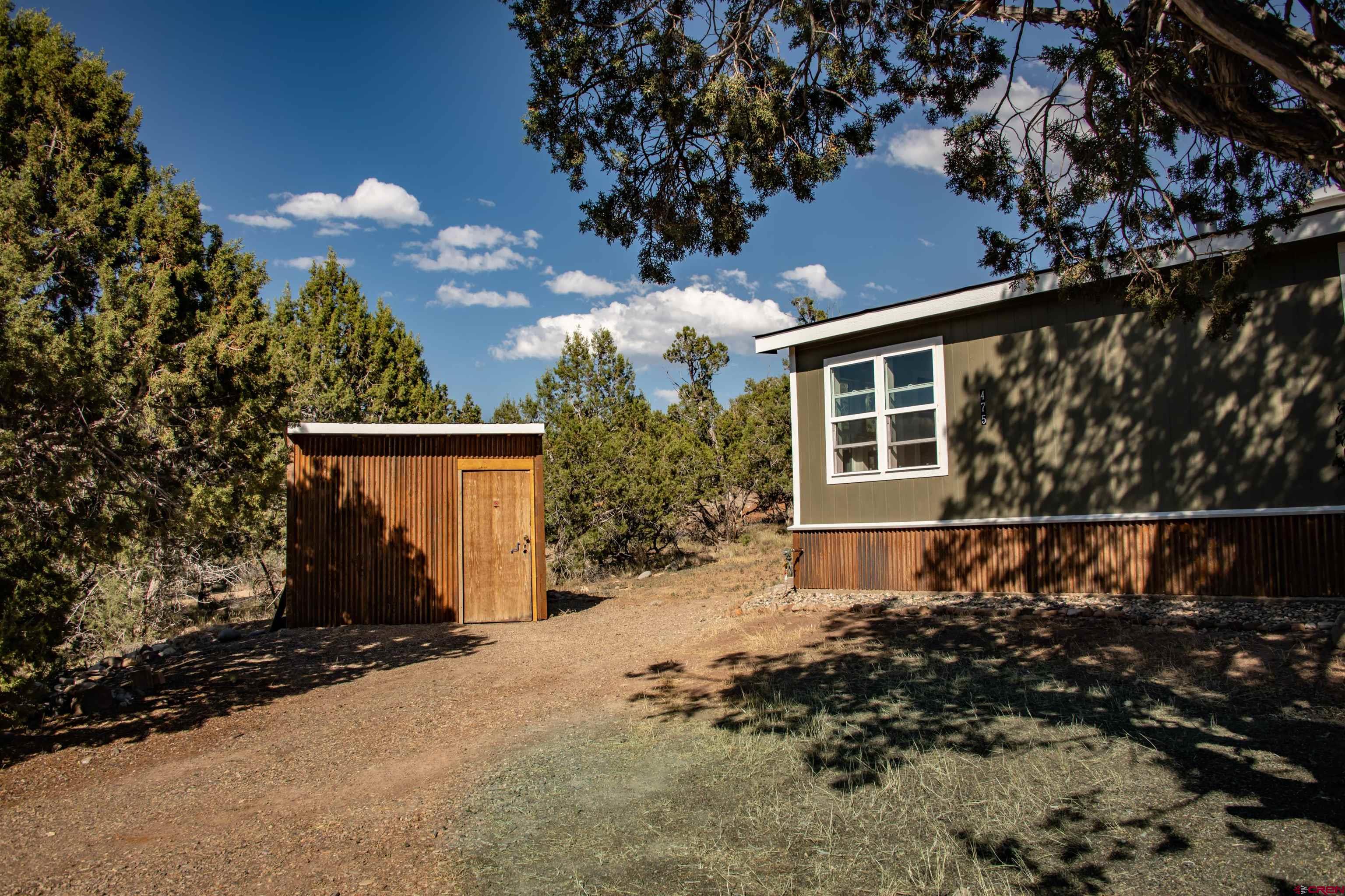 475 Run Around Road Arboles, CO 81121 - Photo 38 of 40 a front view of a house with a yard