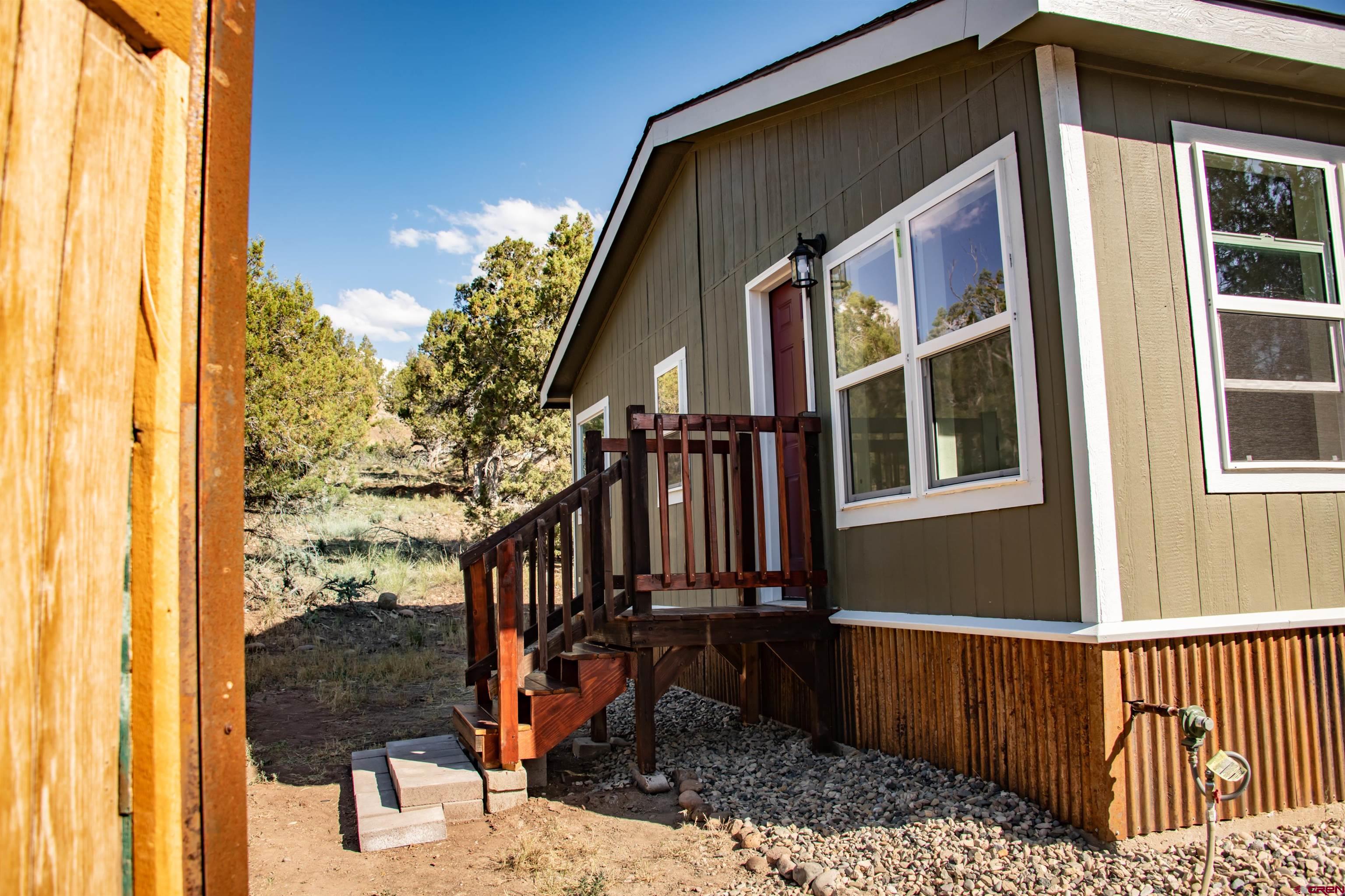 475 Run Around Road Arboles, CO 81121 - Photo 39 of 40 a front view of a house with a yard