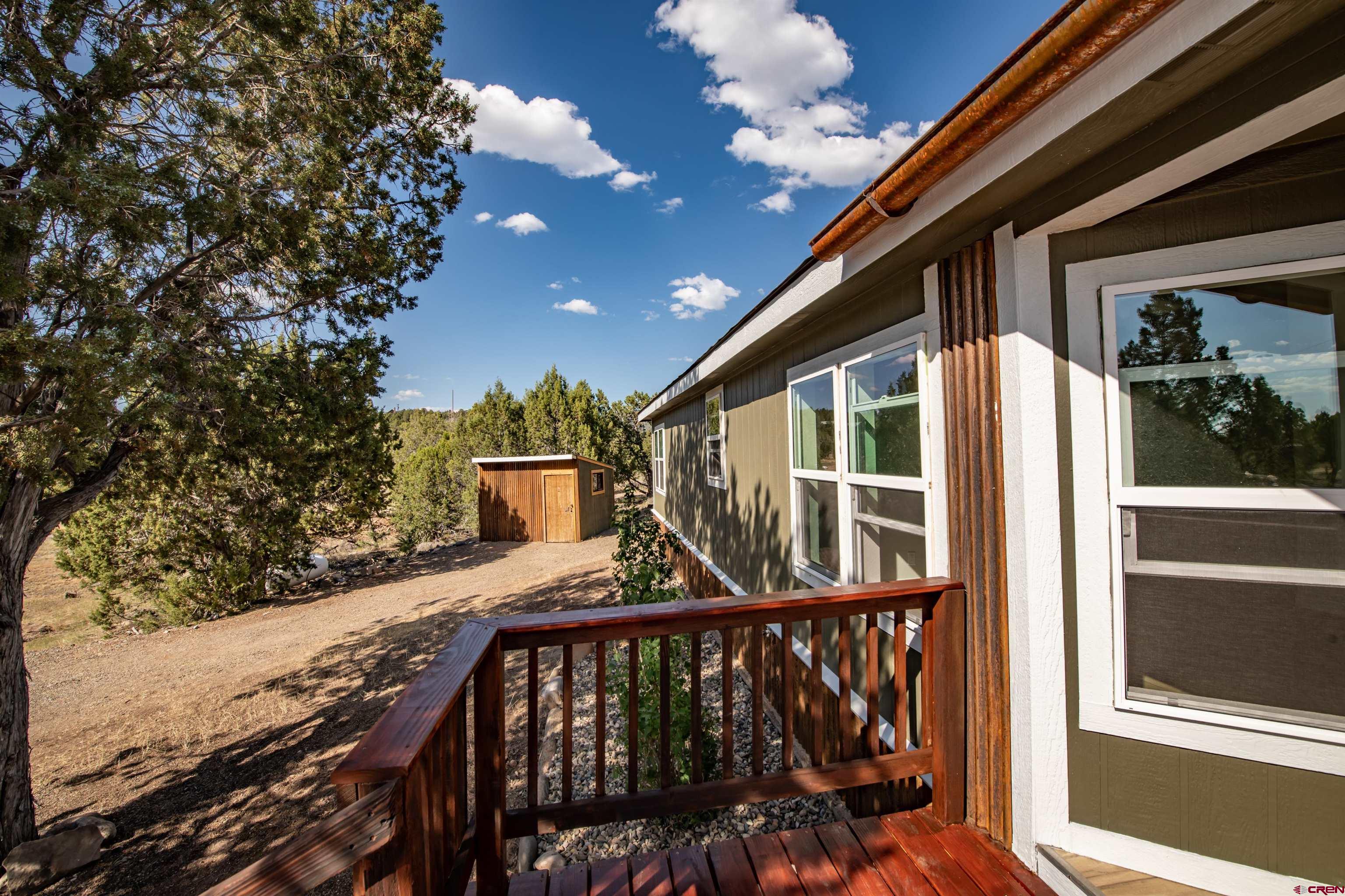 475 Run Around Road Arboles, CO 81121 - Photo 4 of 40 a view of a balcony with two chairs and a table