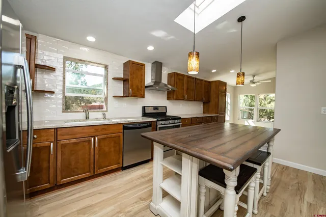 a view of a refrigerator in kitchen and wooden floor