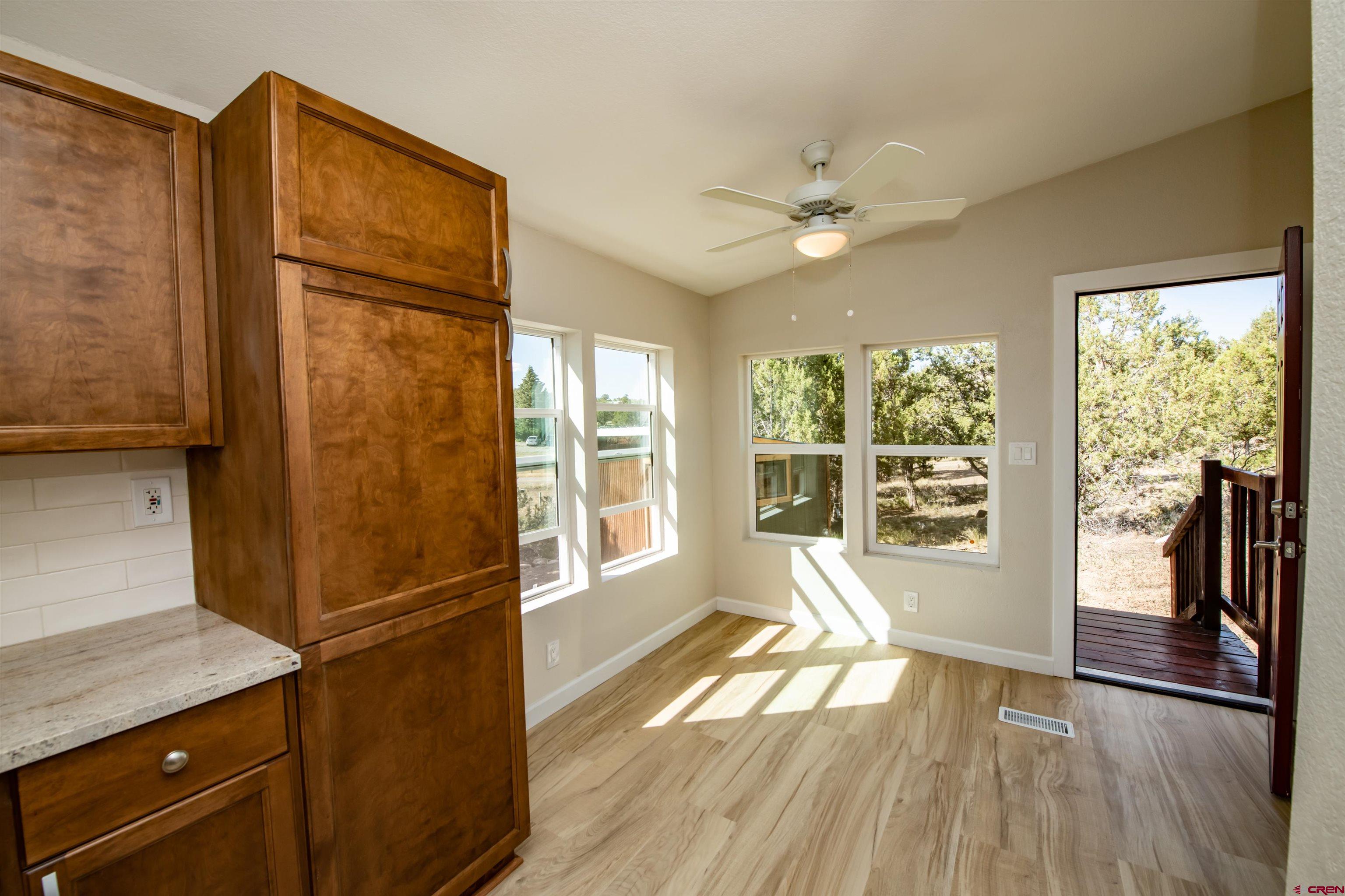 475 Run Around Road Arboles, CO 81121 - Photo 10 of 40 a view of a refrigerator in kitchen and wooden floor
