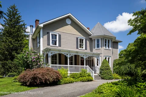 a front view of a house with a garden