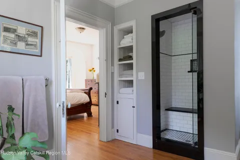 a living room with a bed furniture and a flat screen tv