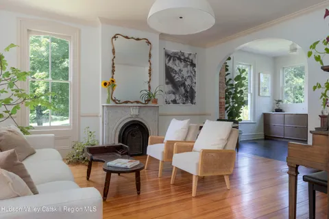 a living room with a couch and a potted plant