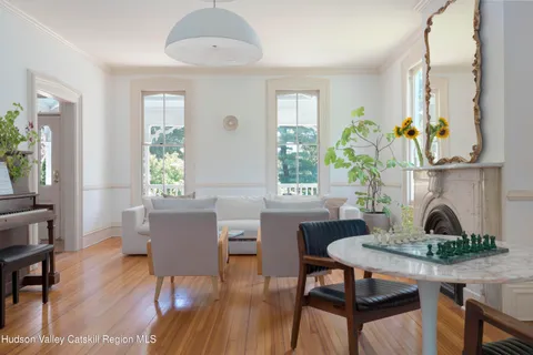 a living room with furniture a fireplace and a window