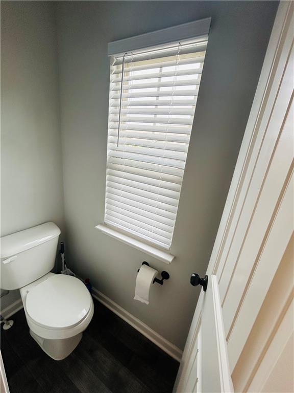 853 Ash Street Canton, GA 30114 - Photo 18 of 23 a bathroom with a toilet a sink and a window