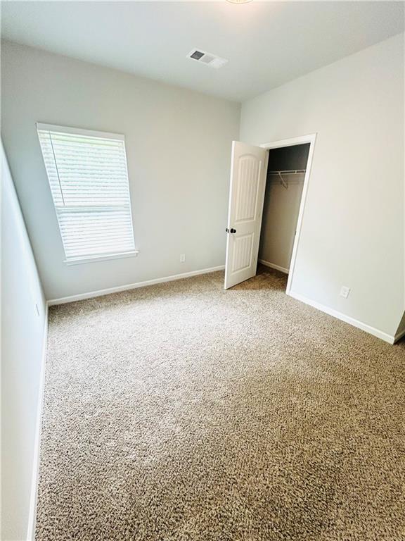 853 Ash Street Canton, GA 30114 - Photo 20 of 23 an empty room with closet and windows