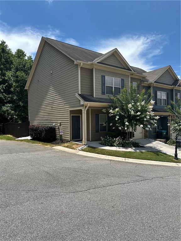 853 Ash Street Canton, GA 30114 - Photo 2 of 23 a front view of a house with a yard and garage