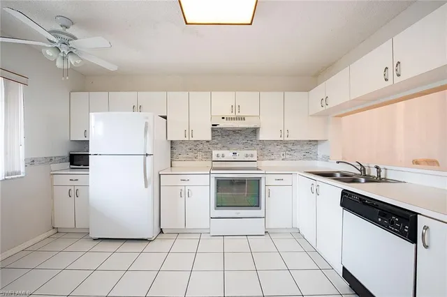 a kitchen with a white stove top oven and refrigerator