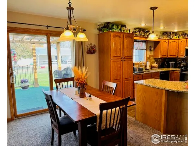 a room with furniture and view of kitchen
