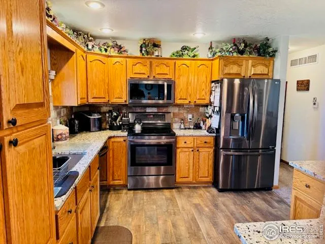 a view of kitchen with refrigerator and window