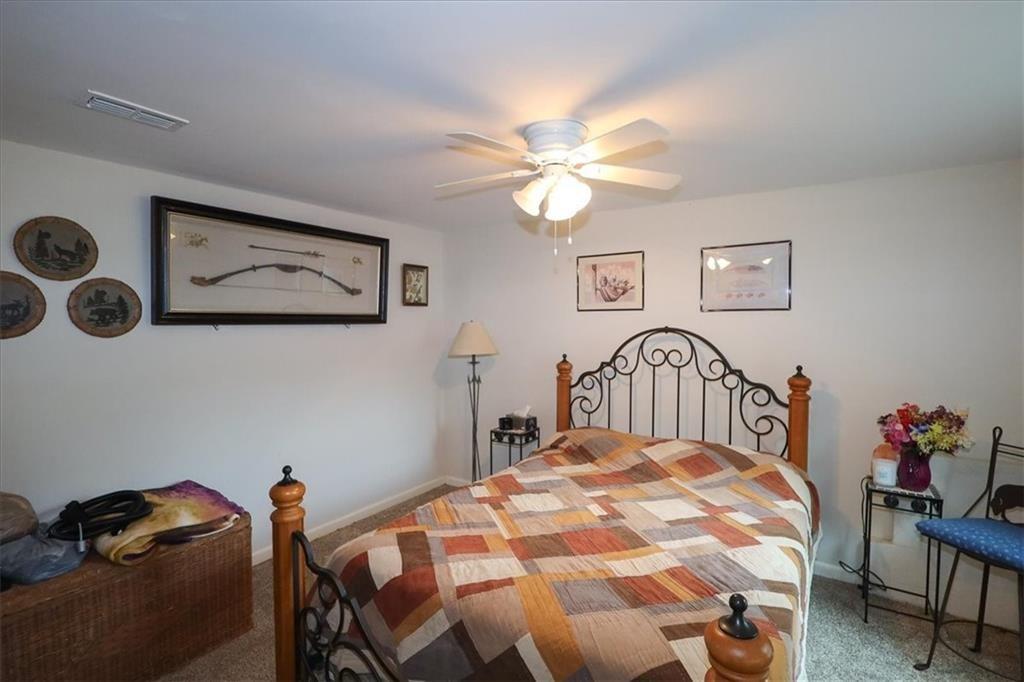 236 Hiram Sudie Road Dallas, GA 30157 - Photo 18 of 26 a bedroom with a bed and a chandelier