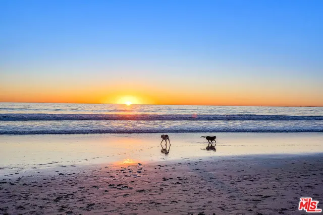 a kitchen with stainless steel appliances kitchen island granite countertop a refrigerator and cabinets