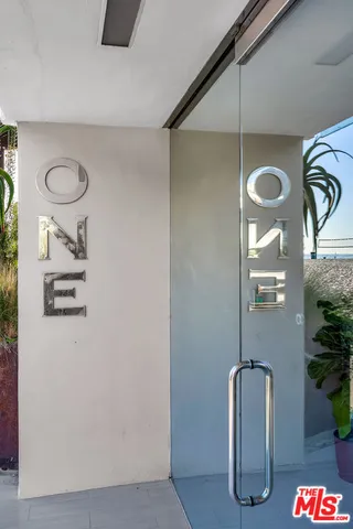 a living room with furniture a large window and a flat screen tv