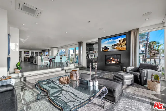 a living room with furniture and view of kitchen