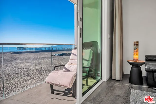 a dining room with furniture and a floor to ceiling window