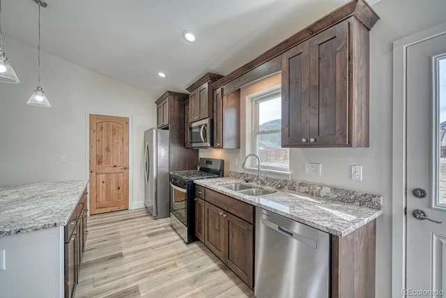 a kitchen with a stove sink and refrigerator