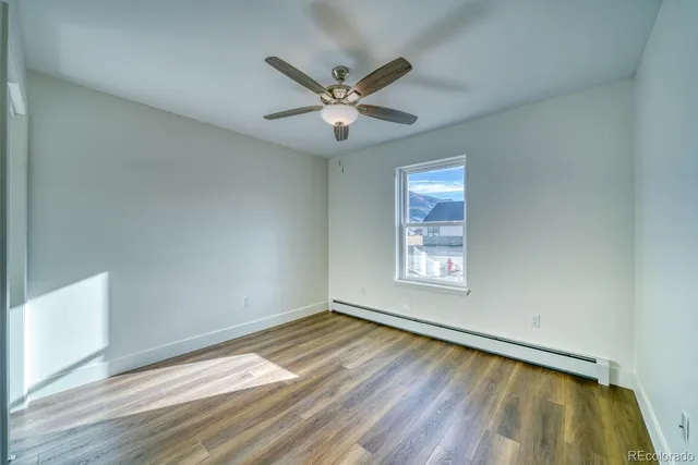 wooden floor in an empty room with a window