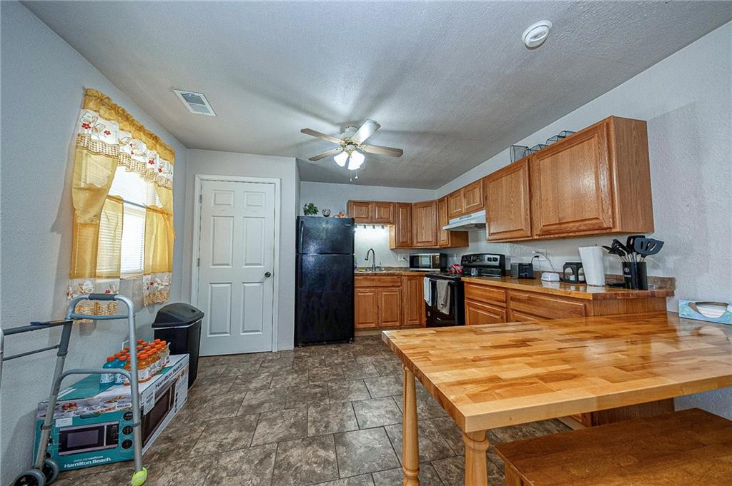 249 Washington Road, Unit 3 Waynesburg, PA 15370 - Photo 4 of 10 a kitchen with stainless steel appliances granite countertop a sink refrigerator stove and microwave