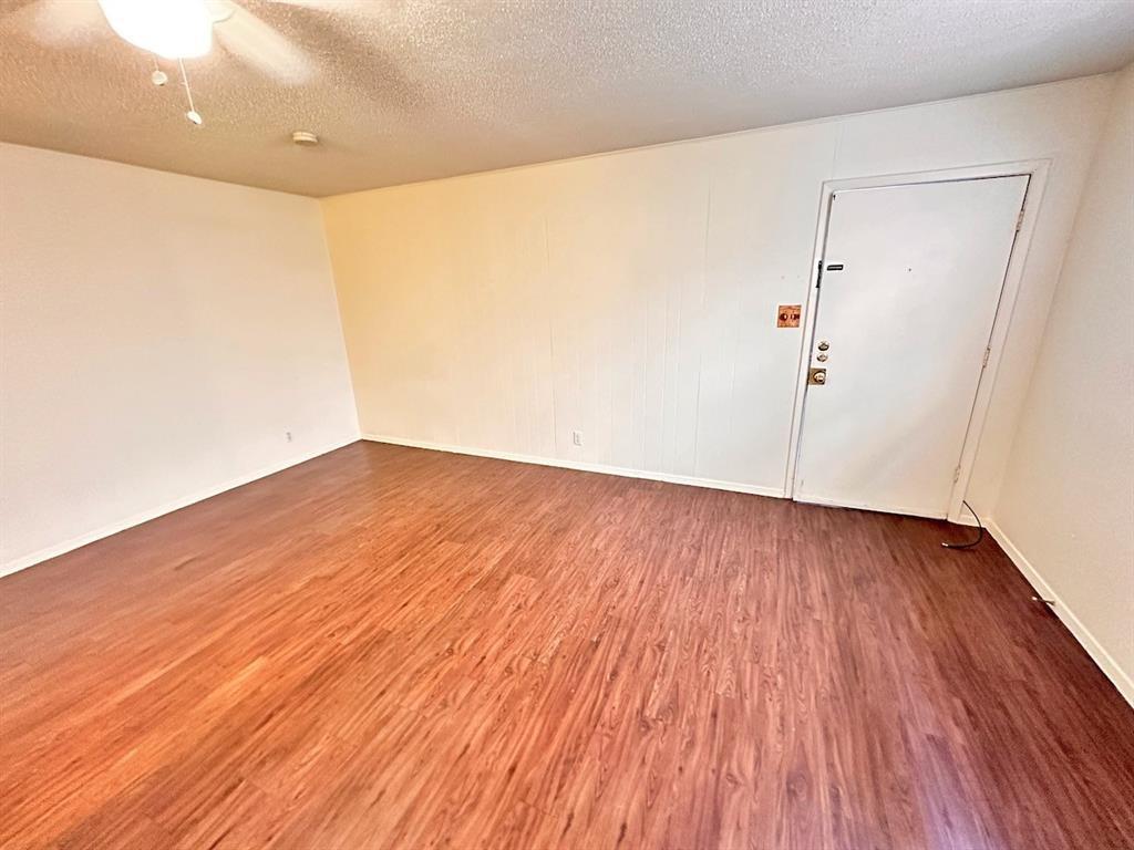 4204 Speedway, Unit 105 Austin, TX 78751 - Photo 3 of 13 a view of an empty room with wooden floor
