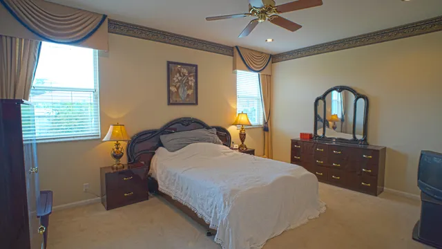 a bedroom with a bed and a dresser with mirror