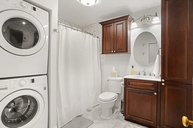 a bathroom with a sink mirror and toilet