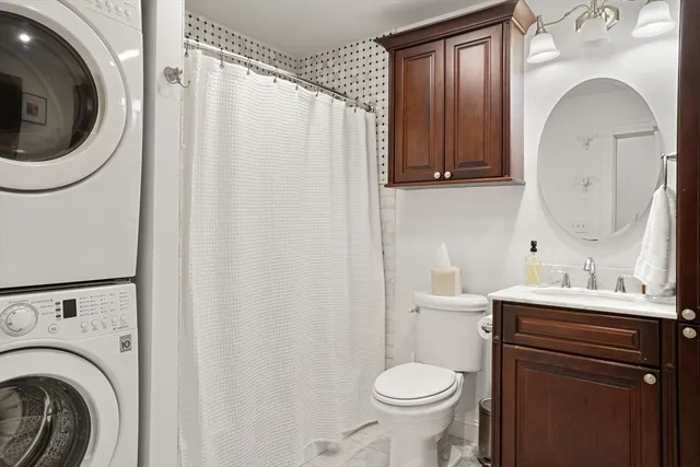 a bathroom with a sink a toilet and a mirror