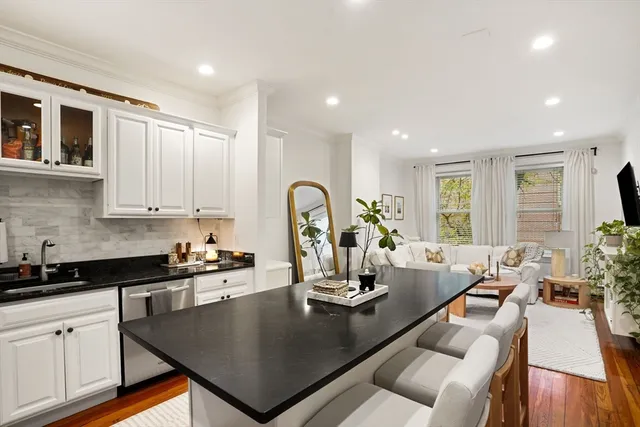 a kitchen with a table chairs stove and cabinets