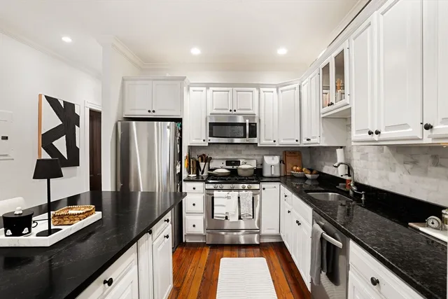a kitchen with stainless steel appliances granite countertop a stove a sink dishwasher and a refrigerator